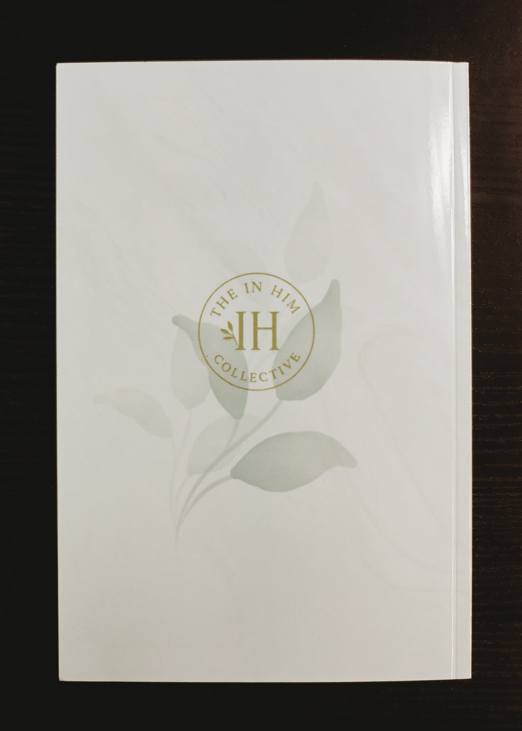Glossy cream, marble journal back cover with green leaves and In Him Collective logo.