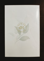Glossy cream, marble journal back cover with green leaves and In Him Collective logo.