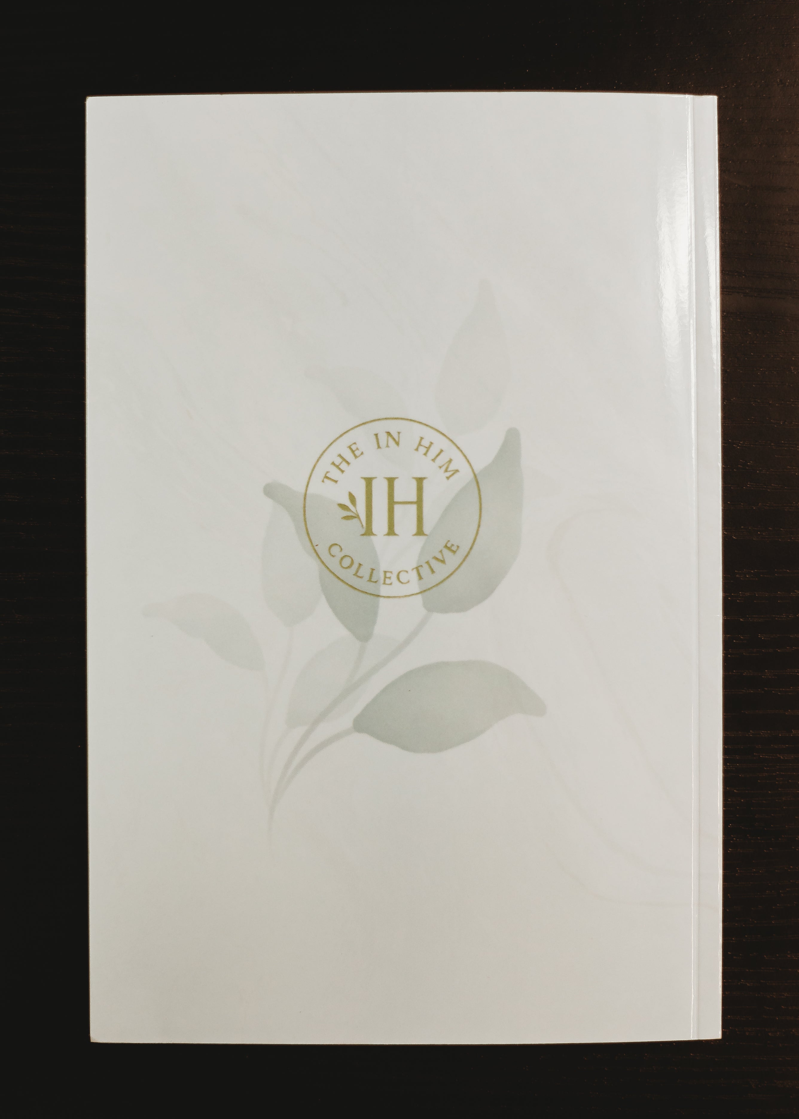 Glossy cream, marble journal back cover with green leaves and In Him Collective logo.